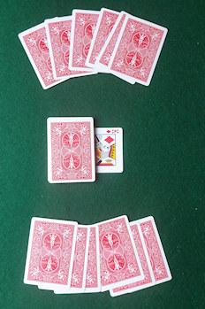 After the first stage of the deal. 6-card hands and stock with trump indicator.